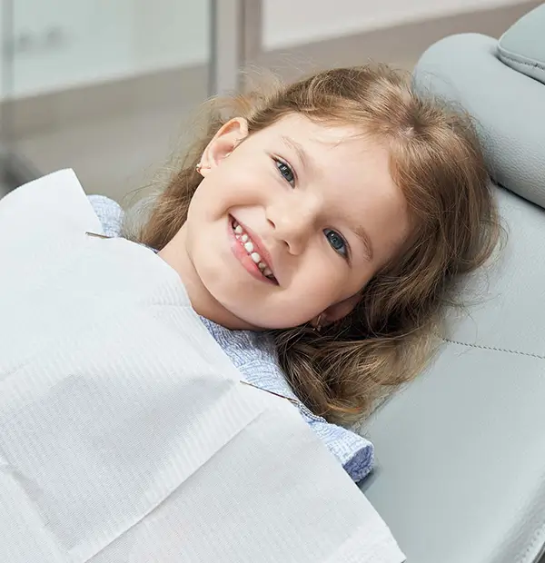 Happy child showing a bright smile after pediatric restorative dentistry.